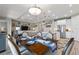 Open-concept dining area featuring a wooden table set for a meal, flowing into the kitchen and living room at 1948 Molise Dr, Kissimmee, FL 34759