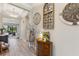 Inviting entryway with wood-look tile flooring, decorative wall art, and a charming console table at 1948 Molise Dr, Kissimmee, FL 34759