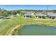 A lovely property with a pond view, manicured lawn, and mature trees at 1948 Molise Dr, Kissimmee, FL 34759
