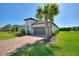 Well-maintained home with brick driveway, palm trees, and manicured lawn at 1948 Molise Dr, Kissimmee, FL 34759