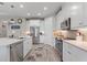 Modern kitchen featuring white cabinetry, stainless steel appliances, and a spacious island at 1948 Molise Dr, Kissimmee, FL 34759
