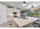 Modern kitchen with white cabinetry, stainless steel appliances, a large island, and pendant lighting at 1948 Molise Dr, Kissimmee, FL 34759