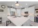 Bright kitchen featuring a large island, stainless steel appliances, and sleek white cabinetry at 1948 Molise Dr, Kissimmee, FL 34759