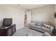 Inviting living room features a comfortable gray sofa and a TV on a dark wooden stand at 1948 Molise Dr, Kissimmee, FL 34759