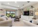 Comfortable living room with large windows, plush seating, built-in shelving, and a view to the outdoors at 1948 Molise Dr, Kissimmee, FL 34759