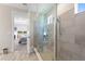 Modern main bathroom with a glass-enclosed shower and partial view to main bedroom at 1948 Molise Dr, Kissimmee, FL 34759