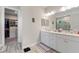 Bright main bathroom features double sinks, a walk-in shower, and access to a walk-in closet at 1948 Molise Dr, Kissimmee, FL 34759