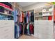 Organized walk-in closet with custom shelving, drawers, and hanging rods at 1948 Molise Dr, Kissimmee, FL 34759