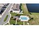 Aerial view of townhomes with community pool, clubhouse, pond, parking and solar panels at 208 Feltrim Reserve Blvd, Davenport, FL 33837