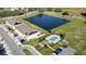 Aerial view of townhomes with community pool, clubhouse, pond, parking and solar panels at 208 Feltrim Reserve Blvd, Davenport, FL 33837