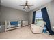 Bedroom room with a crib and a recliner chair at 208 Feltrim Reserve Blvd, Davenport, FL 33837