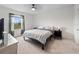 Bedroom with carpet, ceiling fan, dresser, and a large window with a scenic view at 208 Feltrim Reserve Blvd, Davenport, FL 33837