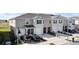 Charming townhomes featuring attached garages and landscaping at 208 Feltrim Reserve Blvd, Davenport, FL 33837
