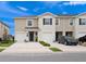 Inviting two-story townhome with attached garages and well-maintained landscaping at 208 Feltrim Reserve Blvd, Davenport, FL 33837