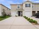 Charming townhomes featuring attached garages and landscaping at 208 Feltrim Reserve Blvd, Davenport, FL 33837