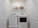 Bright laundry room featuring a modern washer and dryer, with storage shelf above and clean white walls and trim at 208 Feltrim Reserve Blvd, Davenport, FL 33837