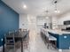 Dining room and kitchen area with modern white cabinets and stainless-steel appliances at 208 Feltrim Reserve Blvd, Davenport, FL 33837
