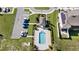 Aerial view of community pool, clubhouse, parking, landscaping and solar panels at 208 Feltrim Reserve Blvd, Davenport, FL 33837