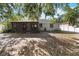 View of a backyard with a screen porch and a fenced area on a sunny day at 218 Cranbrook Dr, Kissimmee, FL 34758