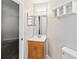 This bathroom features a vanity sink, medicine cabinet, and a shelf for storage at 218 Cranbrook Dr, Kissimmee, FL 34758