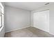 This bedroom has neutral walls and carpet with a closet storage space at 218 Cranbrook Dr, Kissimmee, FL 34758