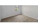 This bedroom has neutral walls, carpet, and a window with blinds at 218 Cranbrook Dr, Kissimmee, FL 34758