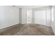 Bedroom with carpeted flooring, white paint, closet doors and a view to the bathroom at 218 Cranbrook Dr, Kissimmee, FL 34758