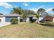 Charming single-story home with a well-maintained lawn and tidy landscaping at 218 Cranbrook Dr, Kissimmee, FL 34758