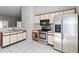 Kitchen with white cabinets, stainless steel appliances, and tiled flooring at 218 Cranbrook Dr, Kissimmee, FL 34758