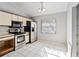 Galley kitchen featuring stainless steel appliances, white cabinetry and neutral paint at 218 Cranbrook Dr, Kissimmee, FL 34758