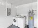 This laundry room has a washer, dryer, and water heater at 218 Cranbrook Dr, Kissimmee, FL 34758