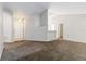 Neutral living room featuring vaulted ceiling, neutral paint, and access to other rooms at 218 Cranbrook Dr, Kissimmee, FL 34758