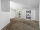 Spacious living room with vaulted ceiling, carpeting, and sliders to a patio at 218 Cranbrook Dr, Kissimmee, FL 34758