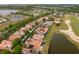Aerial view of a community featuring beautiful homes, serene ponds, and a lush golf course at 2234 Callaway Ct, Davenport, FL 33837