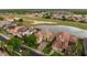 Stunning aerial view of a beautiful home overlooking a golf course, lake, and lush neighborhood at 2234 Callaway Ct, Davenport, FL 33837