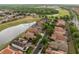 Aerial view of houses and street with a pond next to golf course at 2234 Callaway Ct, Davenport, FL 33837