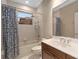 Bright bathroom featuring a single sink vanity with marble countertops, shower and tub combo, and a large mirror at 2234 Callaway Ct, Davenport, FL 33837