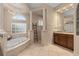 Bright bathroom featuring a standalone tub, shower, and stylish tile work at 2234 Callaway Ct, Davenport, FL 33837