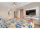 Comfortable bedroom featuring a mounted TV and plenty of natural light at 2234 Callaway Ct, Davenport, FL 33837