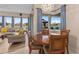 The dining area offers ample natural light from large windows with serene backyard views at 2234 Callaway Ct, Davenport, FL 33837