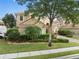 Charming two-story home with a tile roof, lush landscaping, and a well-manicured lawn at 2234 Callaway Ct, Davenport, FL 33837