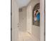 Inviting hallway with neutral tones, archways and artistic details offer a warm welcome at 2234 Callaway Ct, Davenport, FL 33837