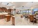Open kitchen and living area boasts wooden cabinets, granite countertops, and plenty of space at 2234 Callaway Ct, Davenport, FL 33837
