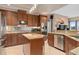 The kitchen is equipped with stainless steel appliances, granite countertops, and wooden cabinetry at 2234 Callaway Ct, Davenport, FL 33837