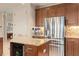 This kitchen features stainless steel appliances, granite counters, and dark wood cabinets at 2234 Callaway Ct, Davenport, FL 33837