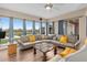 Bright living room featuring large windows, tile floors, and comfortable seating area at 2234 Callaway Ct, Davenport, FL 33837