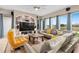 Bright living room featuring large windows, tile floors, and comfortable seating area at 2234 Callaway Ct, Davenport, FL 33837