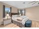 Comfortable bedroom with light wood floors, two windows, ceiling fan, and a bed with decorative pillows at 2234 Callaway Ct, Davenport, FL 33837