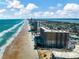 Stunning aerial view of beachfront condos along the sandy coastline on a clear day at 2403 S Atlantic Ave # 501, Daytona Beach Shores, FL 32118
