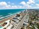 Expansive aerial view of the beautiful coastline, buildings, and the town at 2403 S Atlantic Ave # 501, Daytona Beach Shores, FL 32118